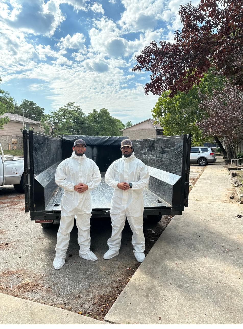 The Big Project Solutions crew suited up at the dump trailer before a cleanout in the Oklahoma City metro