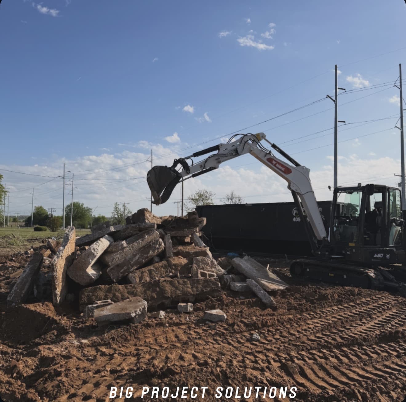 House teardown in progress with a Bobcat working the debris pile in the Oklahoma City metro