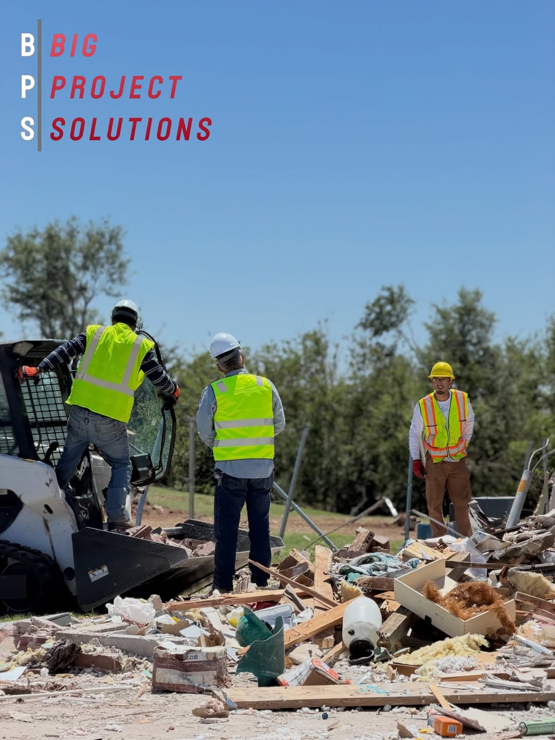 Big Project Solutions crew in hard hats and hi-vis clearing debris from a tornado-damaged home in the Oklahoma City metro